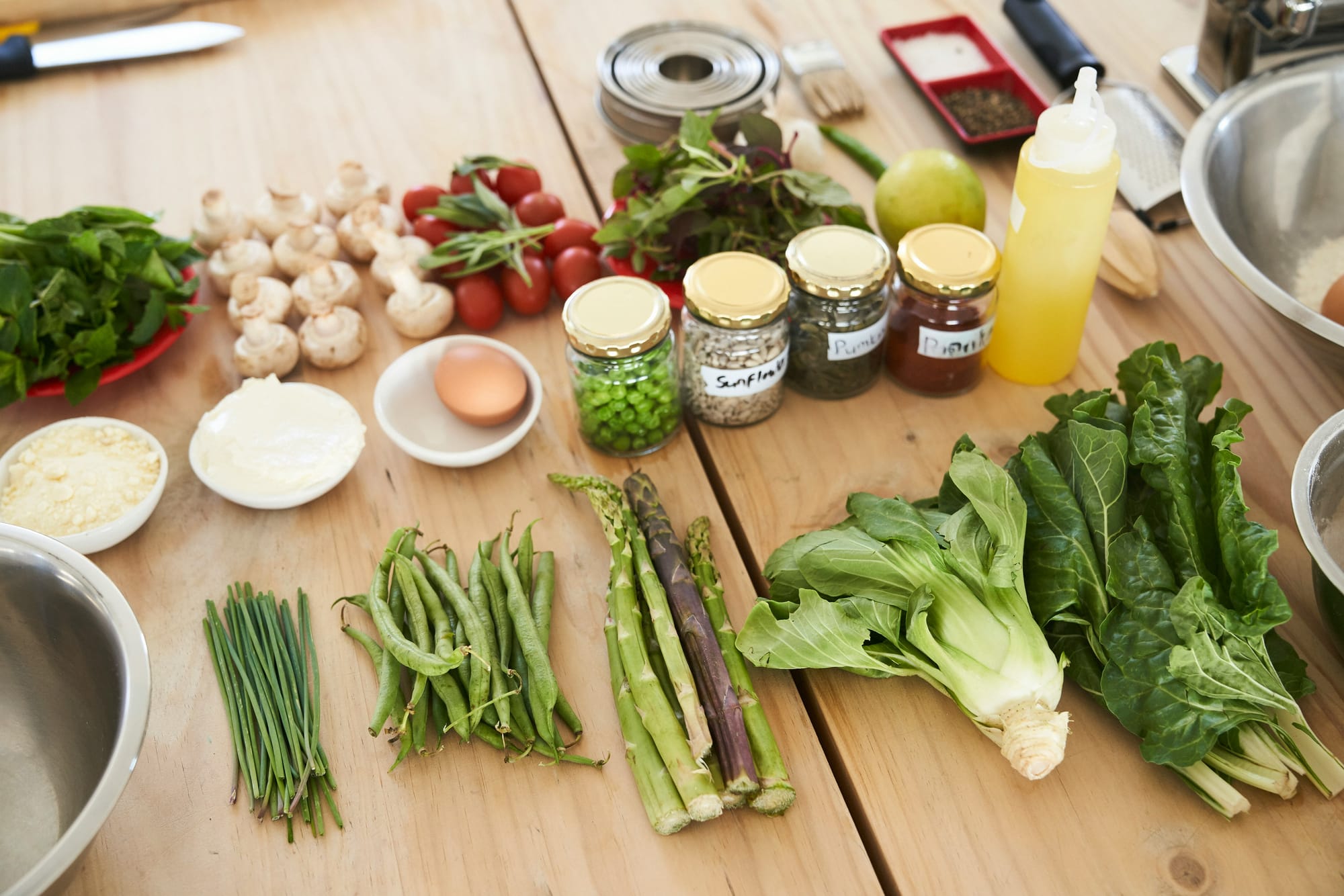 An image of vegetables, seeds, olive oil, and egg, representing a GAPS diet food plan.